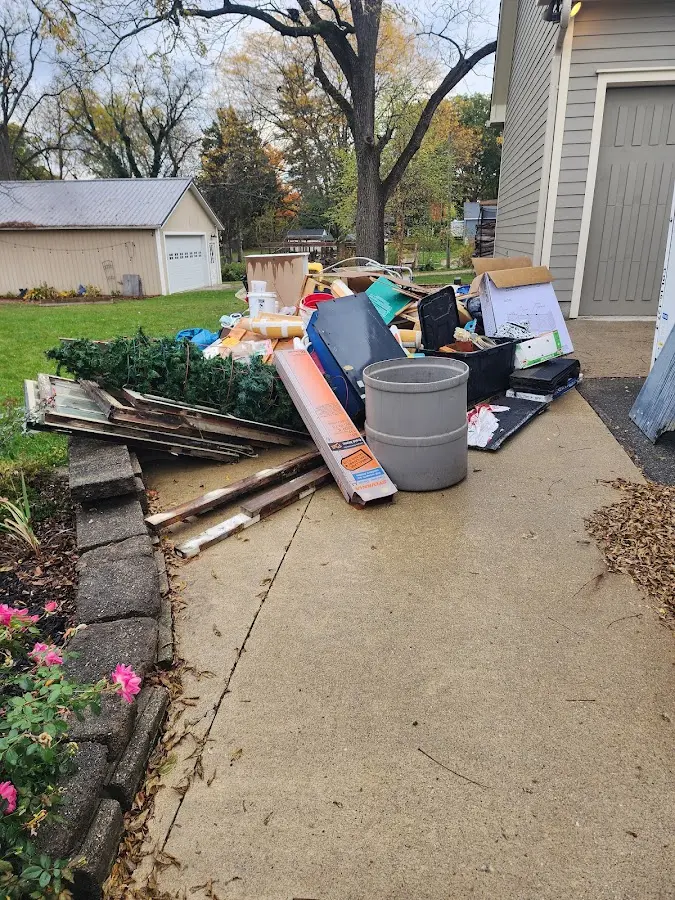 Dumpster being loaded with debris for 12 Yard Dumpster Rental in Alton